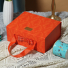 Wholesale Portable Folding Flip Paper Orange Green Gift Cosmetics Skin Care Product Packaging Box with Ribbon Handle